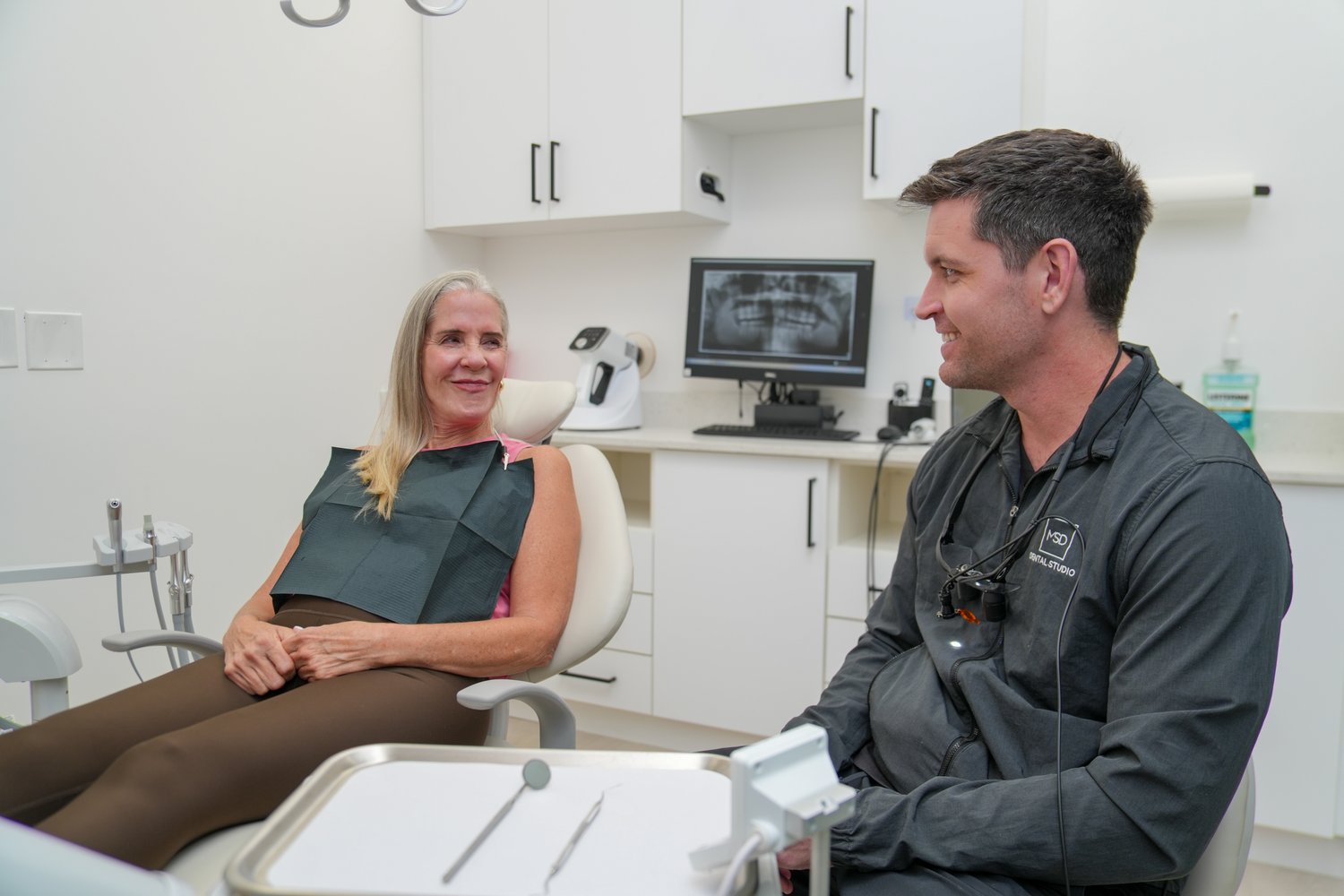 Dr. Matthew Dillon discussing implant options with a patient at MSD Dental Studio